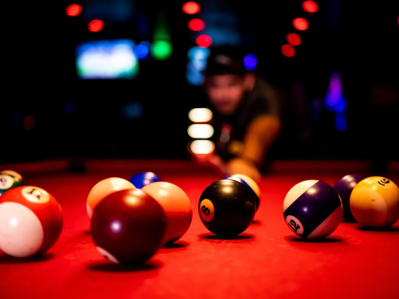 American pool balls on a red table