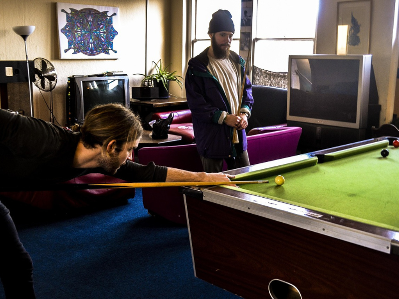 Two men in a bar playing pool